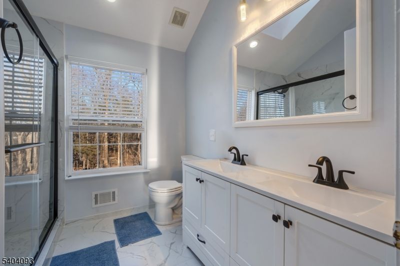 Bathroom, Dual Sink Vanities, Glass Shower, Interior, Marble, Marble Walls, Recessed Lighting