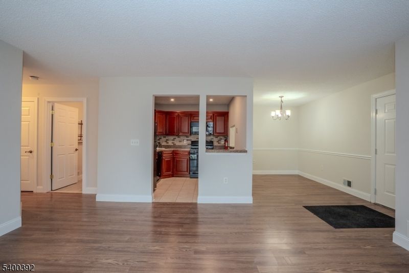 Chandelier, Empty room, Interior, Kitchen, Recessed Lighting, Wood Texture Flooring