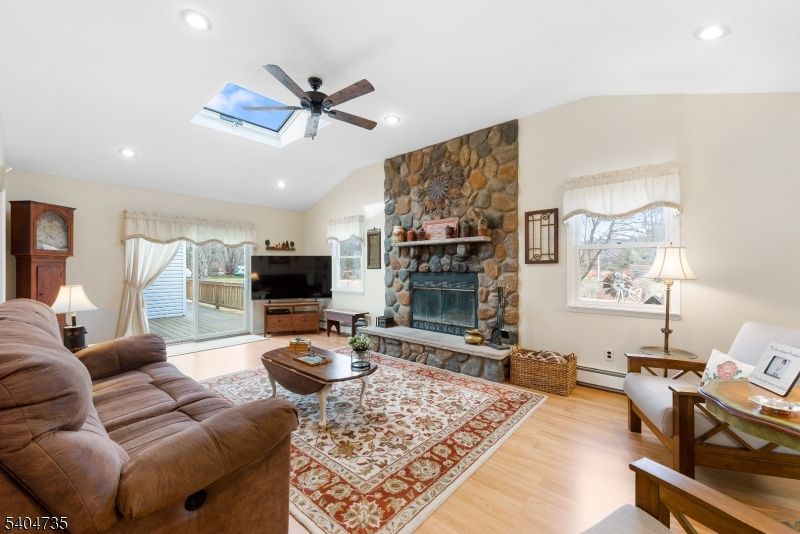 Fireplace, Interior, Living room, Recessed Lighting, Stone Walls, Wood Texture Flooring