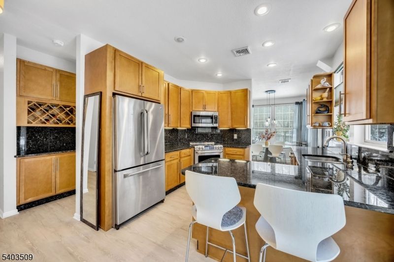 Chandelier, Dining room, Interior, Kitchen, Recessed Lighting, Stainless Steel Appliances, Wood Texture Flooring