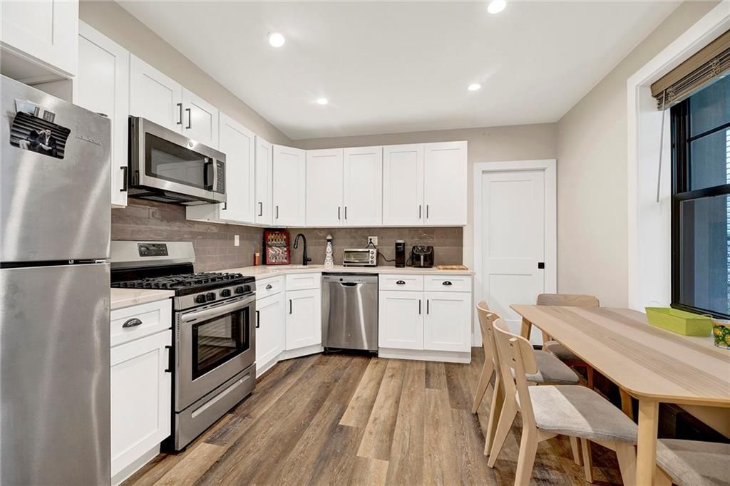 Dining room, Interior, Kitchen, Recessed Lighting, Stainless Steel Appliances, Wood Texture Flooring