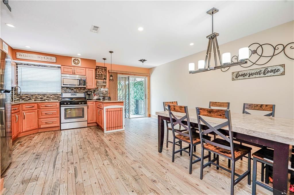 Chandelier, Dining room, Interior, Kitchen, Pendant Lights, Recessed Lighting, Stainless Steel Appliances, Wood Texture Flooring