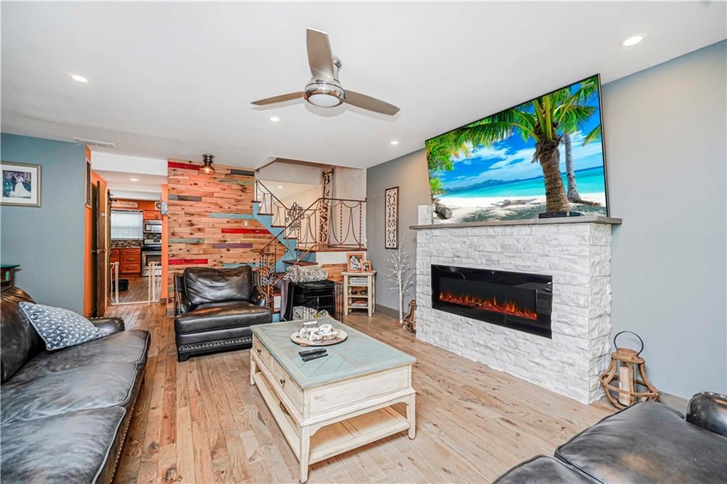 Fireplace, Interior, Living room, Recessed Lighting, Stone Walls, Wood Texture Flooring