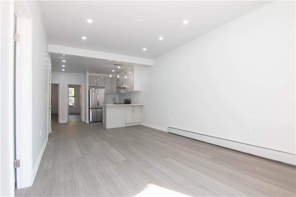 Empty room, Interior, Kitchen, Recessed Lighting, Stainless Steel Appliances, Wood Texture Flooring