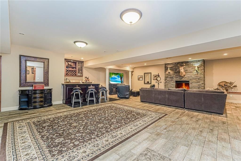 Fireplace, Interior, Living room, Recessed Lighting, Stone Walls, Wood Texture Flooring