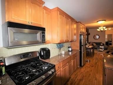 Chandelier, Dining room, Interior, Kitchen, Living room, Stainless Steel Appliances, Wood Texture Flooring
