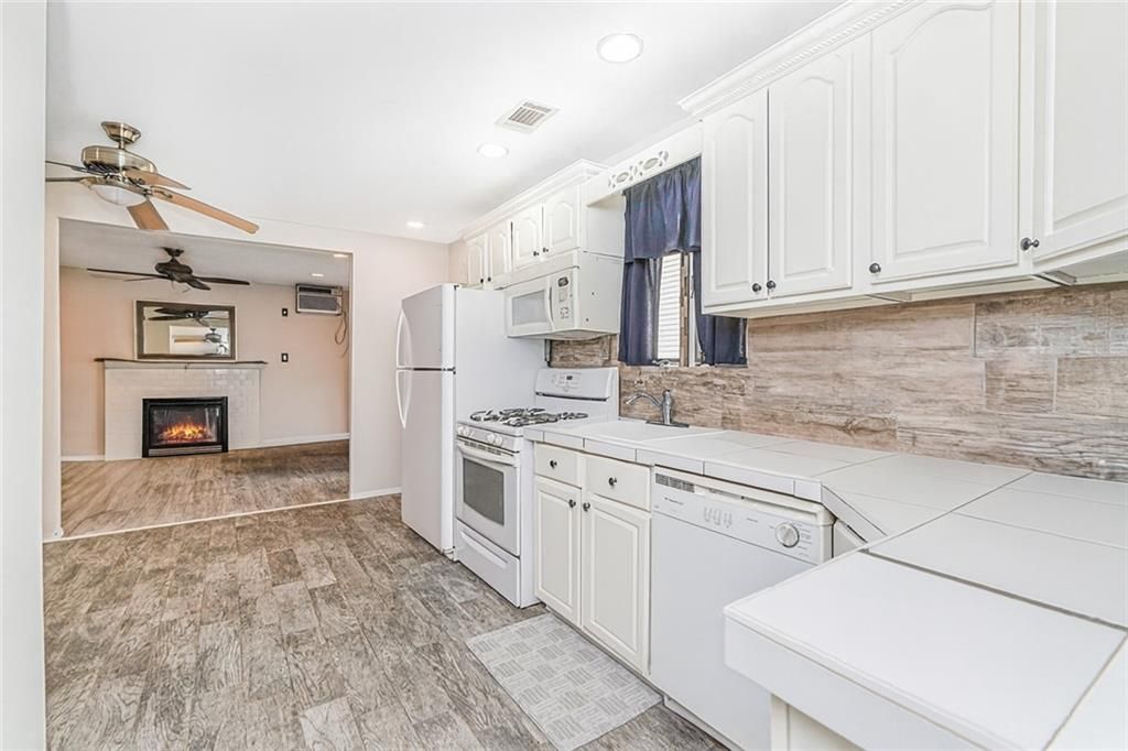 Fireplace, Interior, Kitchen, Recessed Lighting, Tile Countertops