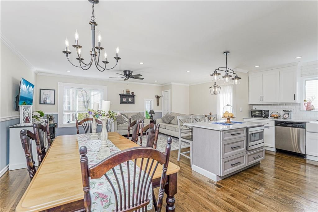 Chandelier, Dining room, Interior, Kitchen, Living room, Pendant Lights, Recessed Lighting, Stainless Steel Appliances, Wood Texture Flooring