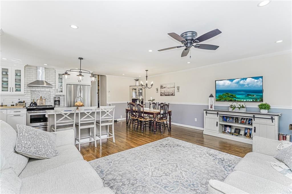 Chandelier, Dining room, Interior, Kitchen, Living room, Pendant Lights, Recessed Lighting, Stainless Steel Appliances, Water, Wood Texture Flooring