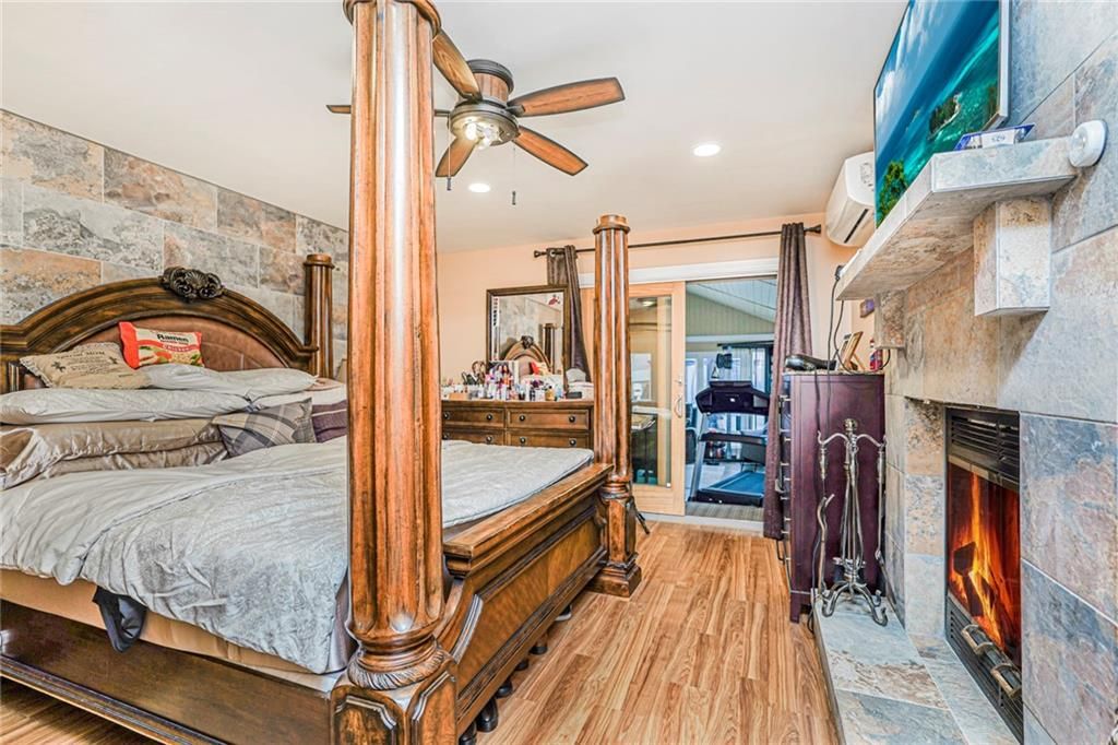 Bedroom, Fireplace, Interior, Recessed Lighting, Stone Walls, Wood Texture Flooring