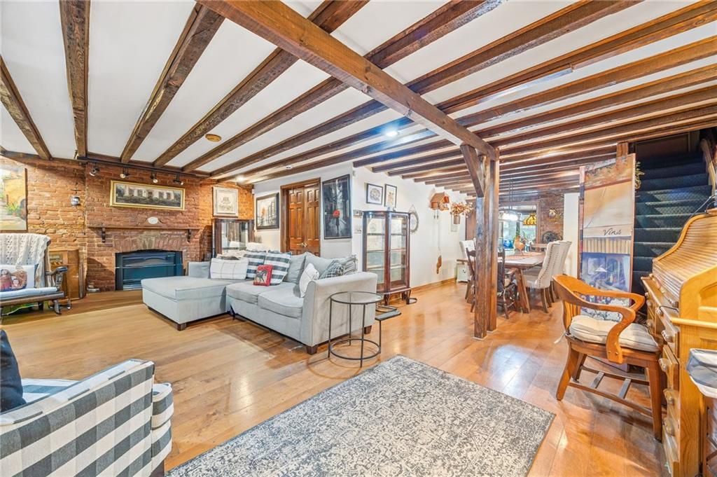 Dining room, Fireplace, Interior, Living room, Stone Walls, Wooden Beams, Wood Texture Flooring