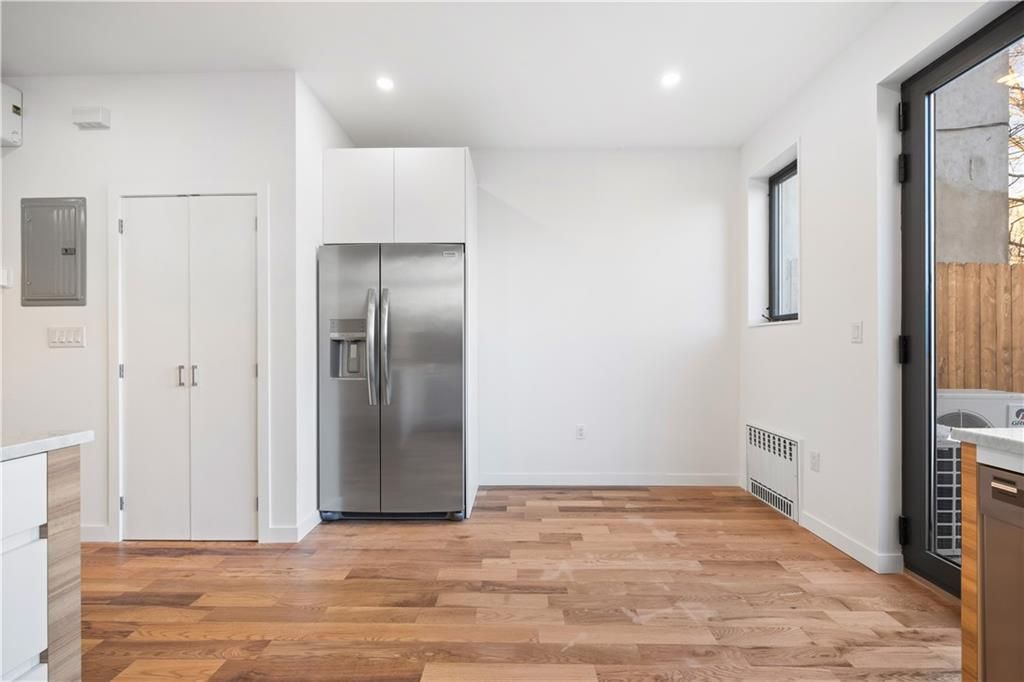 Empty room, Interior, Kitchen, Recessed Lighting, Stainless Steel Appliances, Wood Texture Flooring