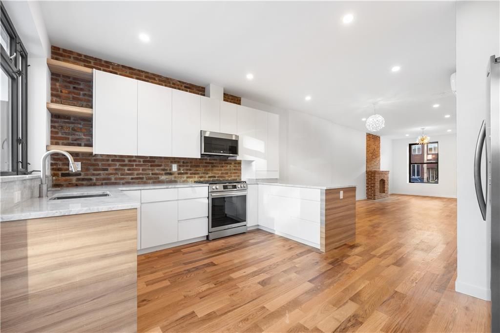Interior, Kitchen, Pendant Lights, Recessed Lighting, Stainless Steel Appliances, Stone Walls, Wood Texture Flooring