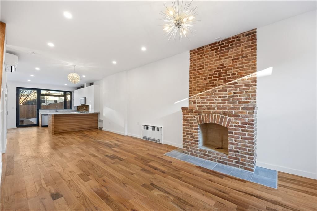 Empty room, Fireplace, Interior, Kitchen, Pendant Lights, Recessed Lighting, Stone Walls, Wood Texture Flooring
