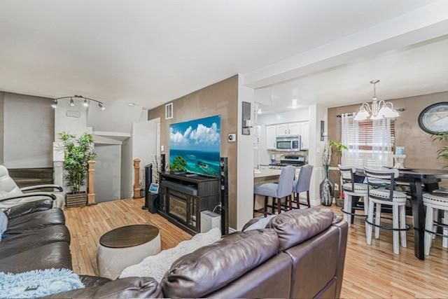 Chandelier, Dining room, Fireplace, Interior, Kitchen, Living room, Stainless Steel Appliances, Water, Wood Texture Flooring