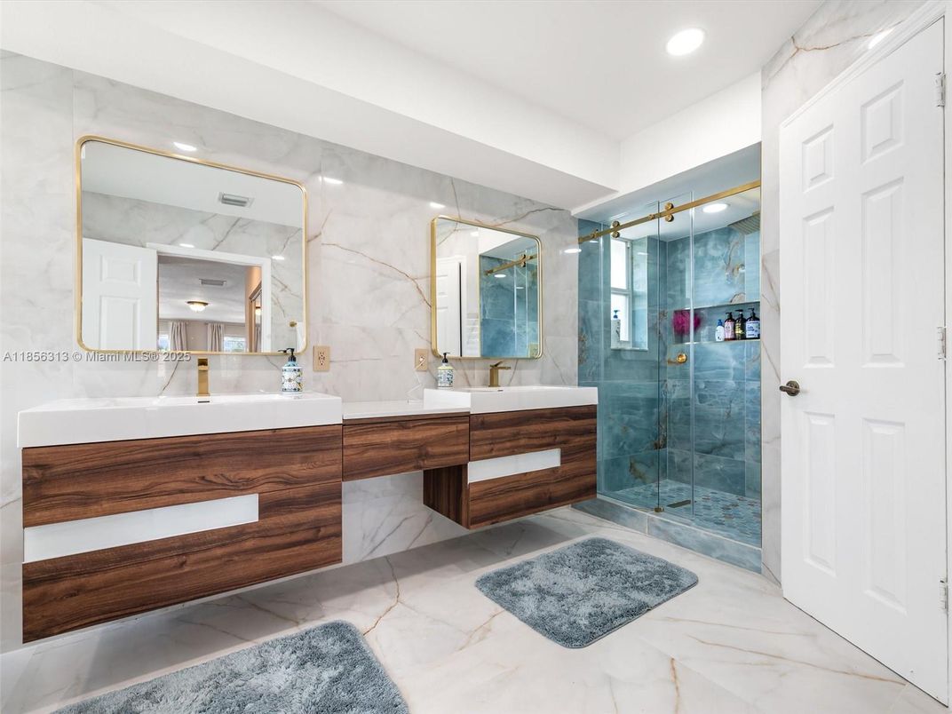 Bathroom, Dual Sink Vanities, Glass Shower, Interior, Marble, Marble Walls, Recessed Lighting