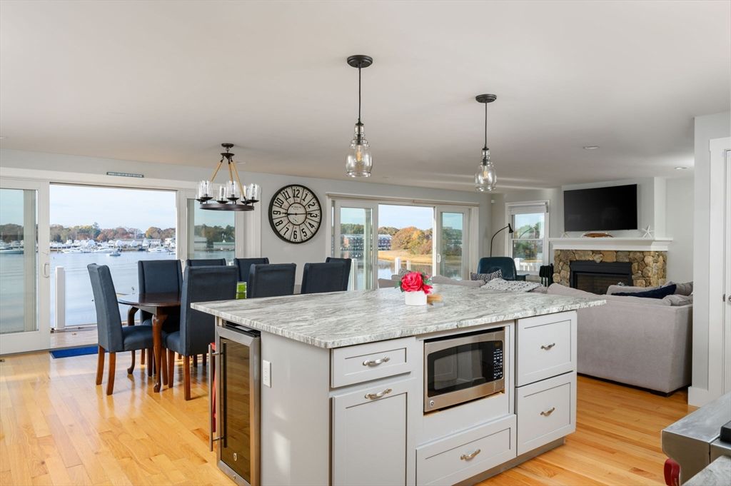 Dining room, Fireplace, Interior, Kitchen, Living room, Pendant Lights, Recessed Lighting, Water, Wood Texture Flooring