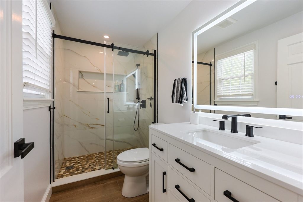 Bathroom, Dual Sink Vanities, Glass Shower, Interior, Marble Walls, Recessed Lighting, Wood Texture Flooring