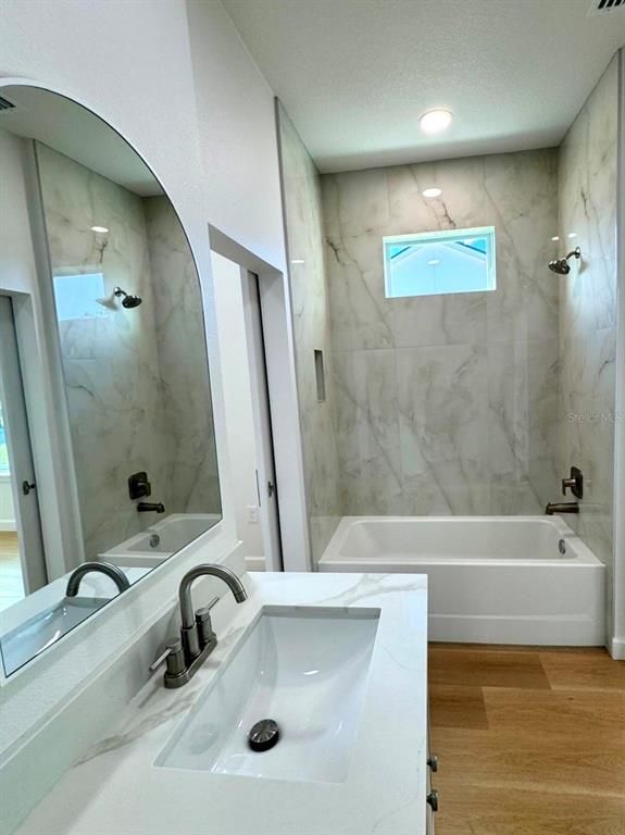 Bathroom, Dual Sink Vanities, Interior, Marble Walls, Recessed Lighting, Wood Texture Flooring