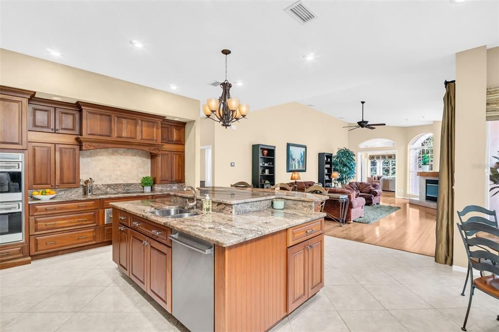 Chandelier, Fireplace, Interior, Kitchen, Living room, Recessed Lighting, Stainless Steel Appliances, Wood Texture Flooring