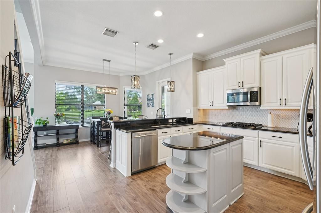 Dining room, Interior, Kitchen, Pendant Lights, Recessed Lighting, Stainless Steel Appliances, Wood Texture Flooring