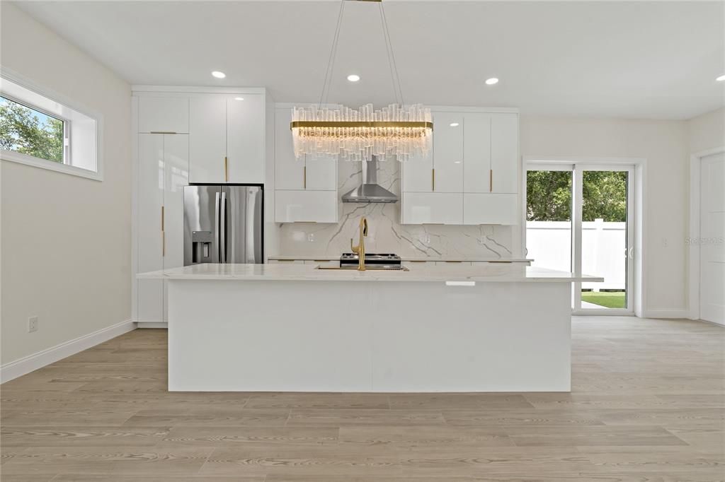Chandelier, Interior, Kitchen, Marble Walls, Recessed Lighting, Stainless Steel Appliances, Wood Texture Flooring
