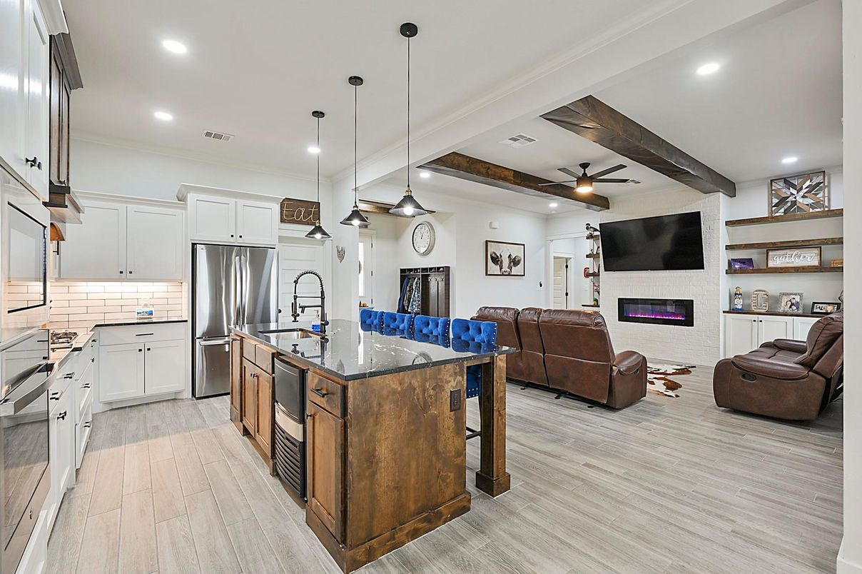 Fireplace, Interior, Kitchen, Living room, Pendant Lights, Recessed Lighting, Stainless Steel Appliances, Wooden Beams, Wood Texture Flooring