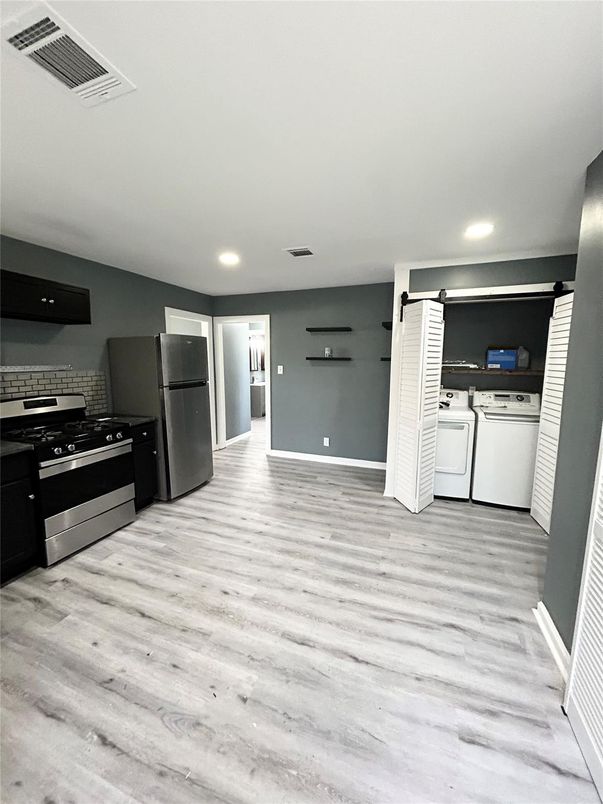 Interior, Kitchen, Recessed Lighting, Washer, Wood Texture Flooring