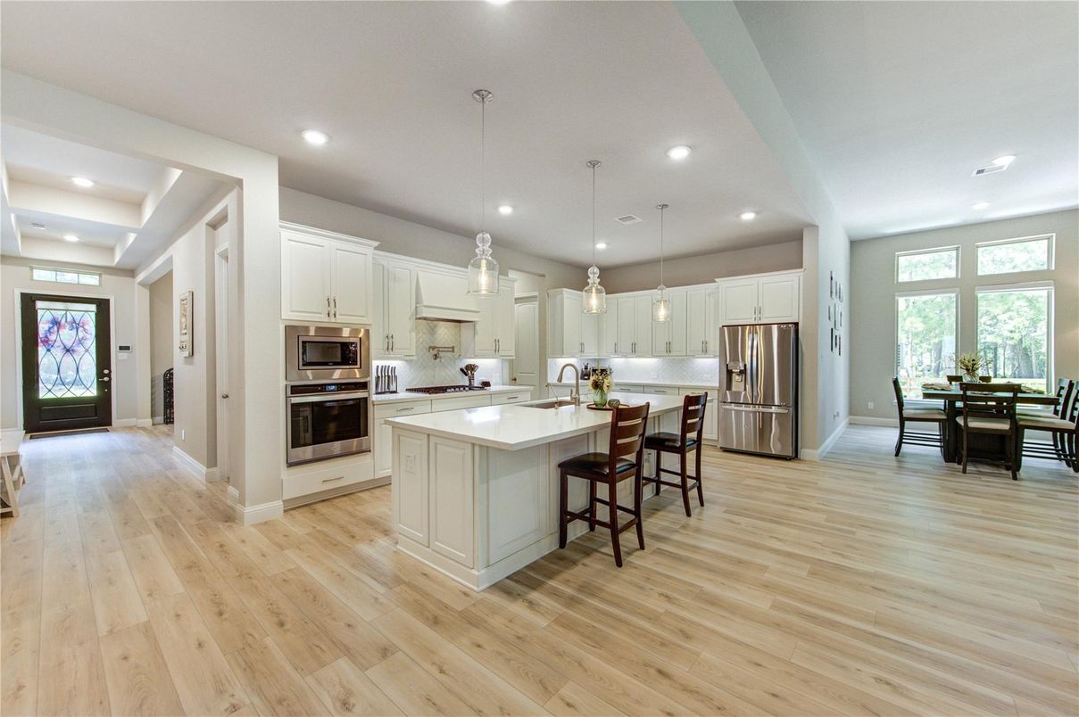Dining room, Interior, Kitchen, Pendant Lights, Recessed Lighting, Stainless Steel Appliances, Wood Texture Flooring