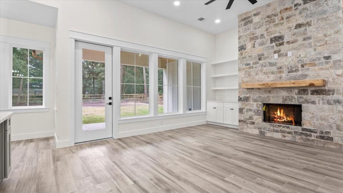 Empty room, Fireplace, Interior, Recessed Lighting, Stone Walls, Wood Texture Flooring