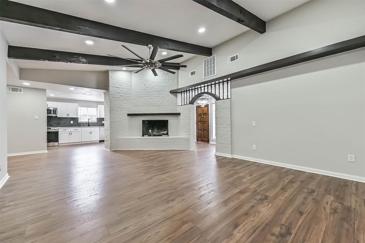 Empty room, Fireplace, Interior, Kitchen, Recessed Lighting, Stone Walls, Wooden Beams, Wood Texture Flooring