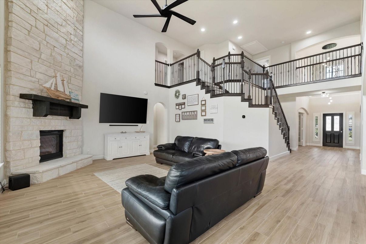 Fireplace, Interior, Living room, Recessed Lighting, Stone Walls, Wood Texture Flooring