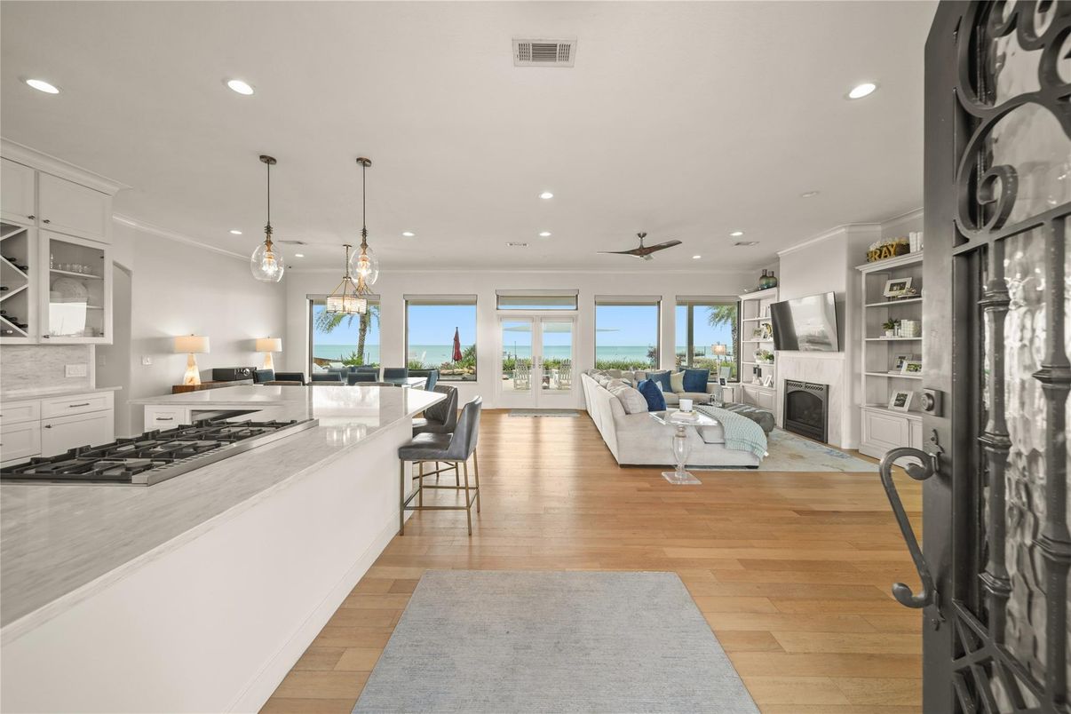 Dining room, Fireplace, Interior, Kitchen, Living room, Pendant Lights, Recessed Lighting, Water, Wood Texture Flooring