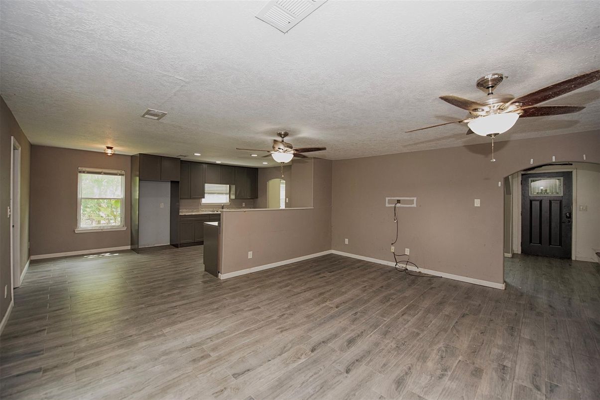 Empty room, Interior, Kitchen, Recessed Lighting, Stainless Steel Appliances, Wood Texture Flooring