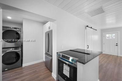 Interior, Kitchen, Recessed Lighting, Stainless Steel Appliances, Utility Closets, Washer, Wood Texture Flooring