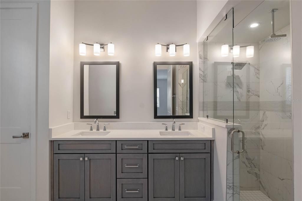 Bathroom, Dual Sink Vanities, Glass Shower, Interior, Marble Walls, Recessed Lighting