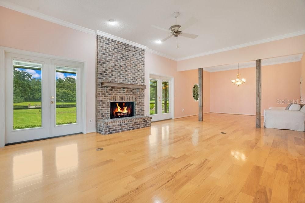 Chandelier, Empty room, Fireplace, Interior, Recessed Lighting, Stone Walls, Wood Texture Flooring