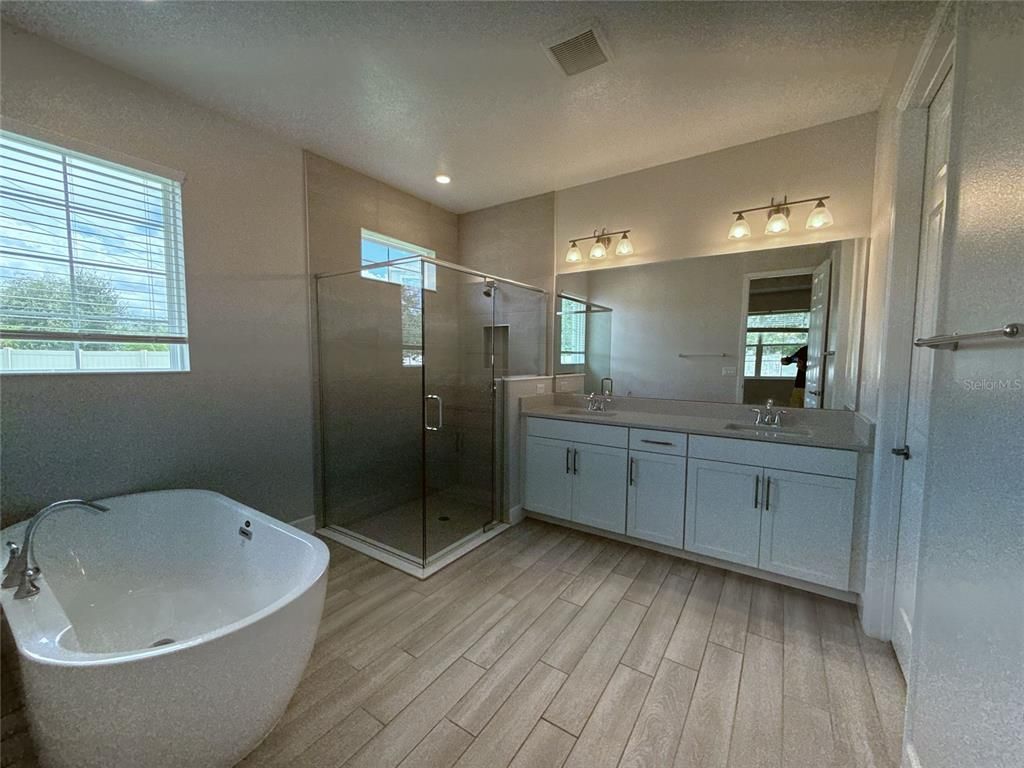 Bathroom, Dual Sink Vanities, Free Standing Baths, Glass Shower, Interior, Recessed Lighting, Wood Texture Flooring