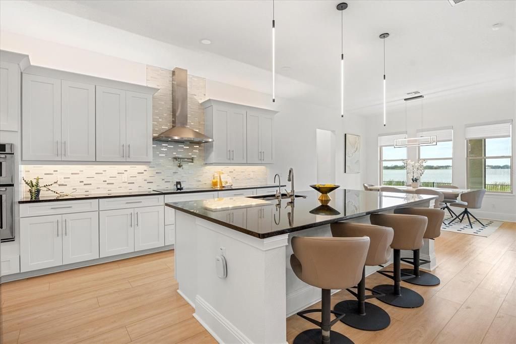 Dining room, Interior, Kitchen, Pendant Lights, Recessed Lighting, Stainless Steel Appliances, Water, Wood Texture Flooring