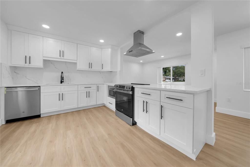 Interior, Kitchen, Marble Walls, Recessed Lighting, Stainless Steel Appliances, Wood Texture Flooring