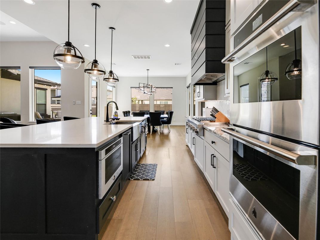Dining room, Interior, Kitchen, Pendant Lights, Recessed Lighting, Stainless Steel Appliances, Wood Texture Flooring