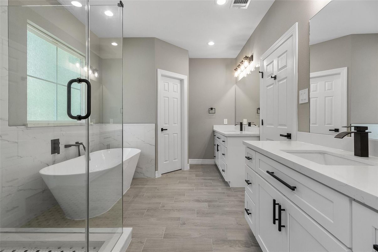 Bathroom, Dual Sink Vanities, Free Standing Baths, Glass Shower, Interior, Marble Walls, Recessed Lighting, Wood Texture Flooring