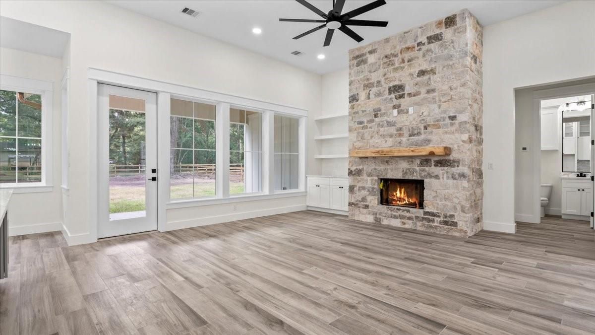 Empty room, Fireplace, Interior, Recessed Lighting, Stone Walls, Wood Texture Flooring