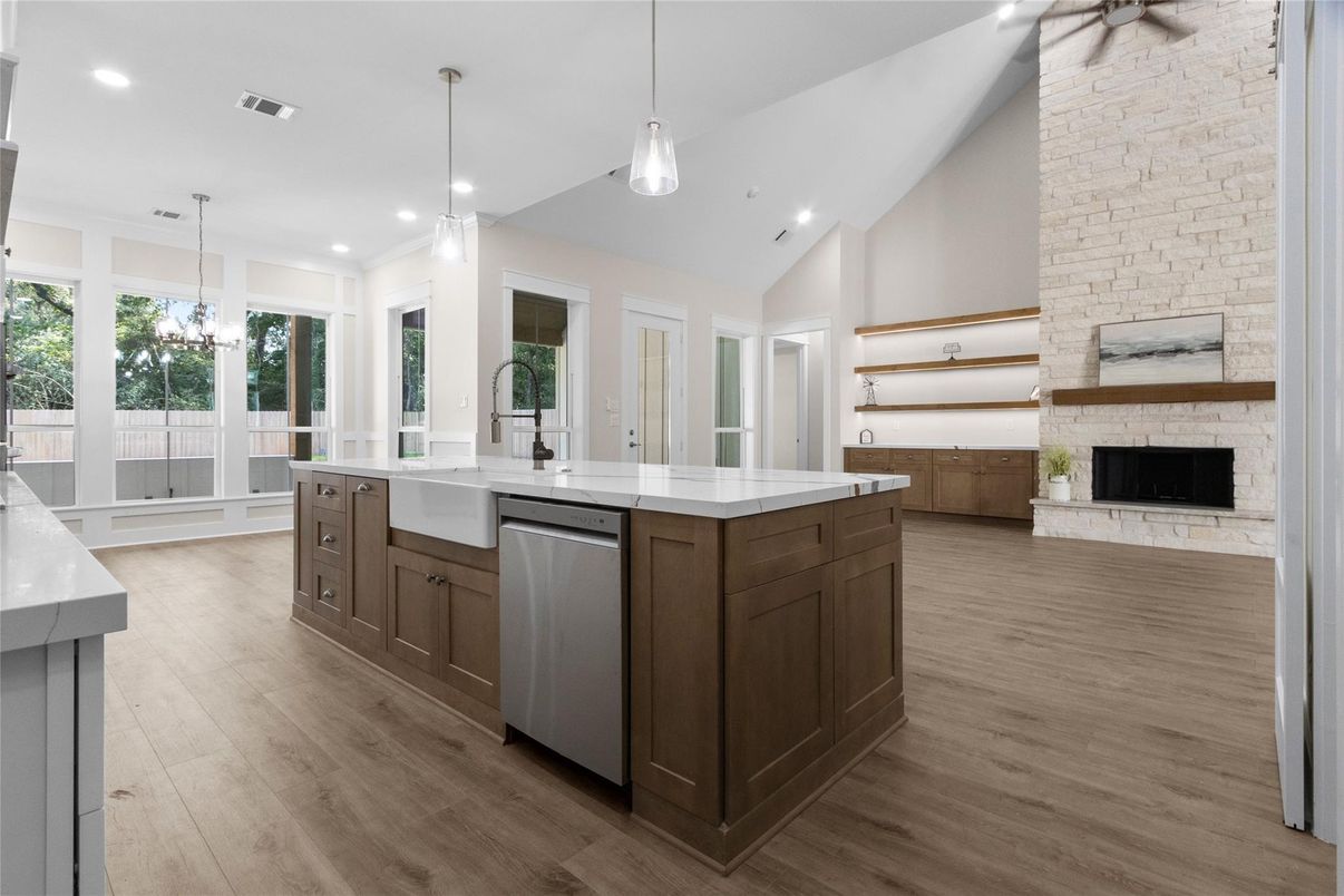 Fireplace, Interior, Kitchen, Pendant Lights, Recessed Lighting, Stainless Steel Appliances, Stone Walls, Wood Texture Flooring