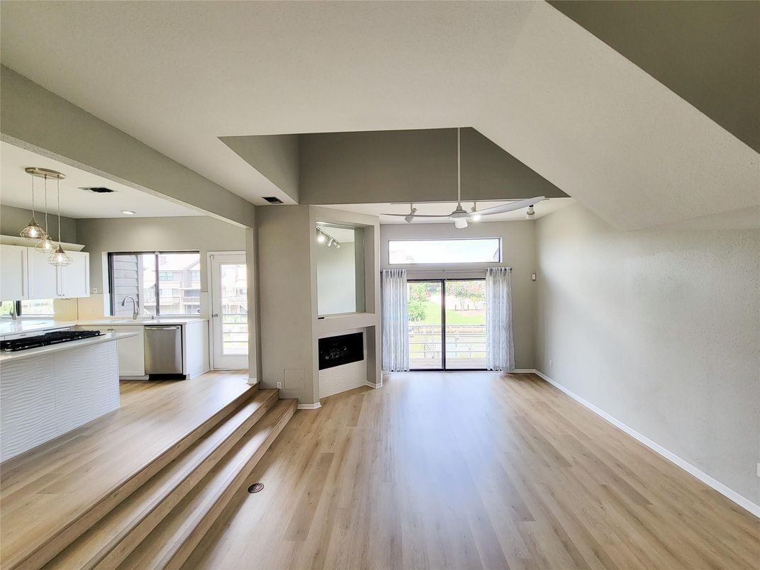 Empty room, Fireplace, Interior, Kitchen, Pendant Lights, Recessed Lighting, Wood Texture Flooring