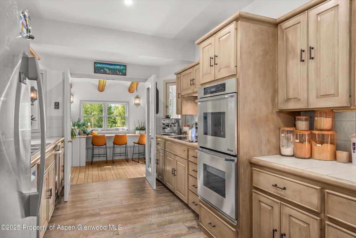 Dining room, Interior, Kitchen, Stainless Steel Appliances, Tile Countertops, Wood Texture Flooring