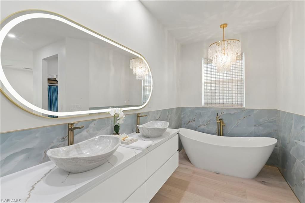 Bathroom, Dual Sink Vanities, Glass Shower, Interior, Marble Walls, Pendant Lights, Recessed Lighting, Wood Texture Flooring
