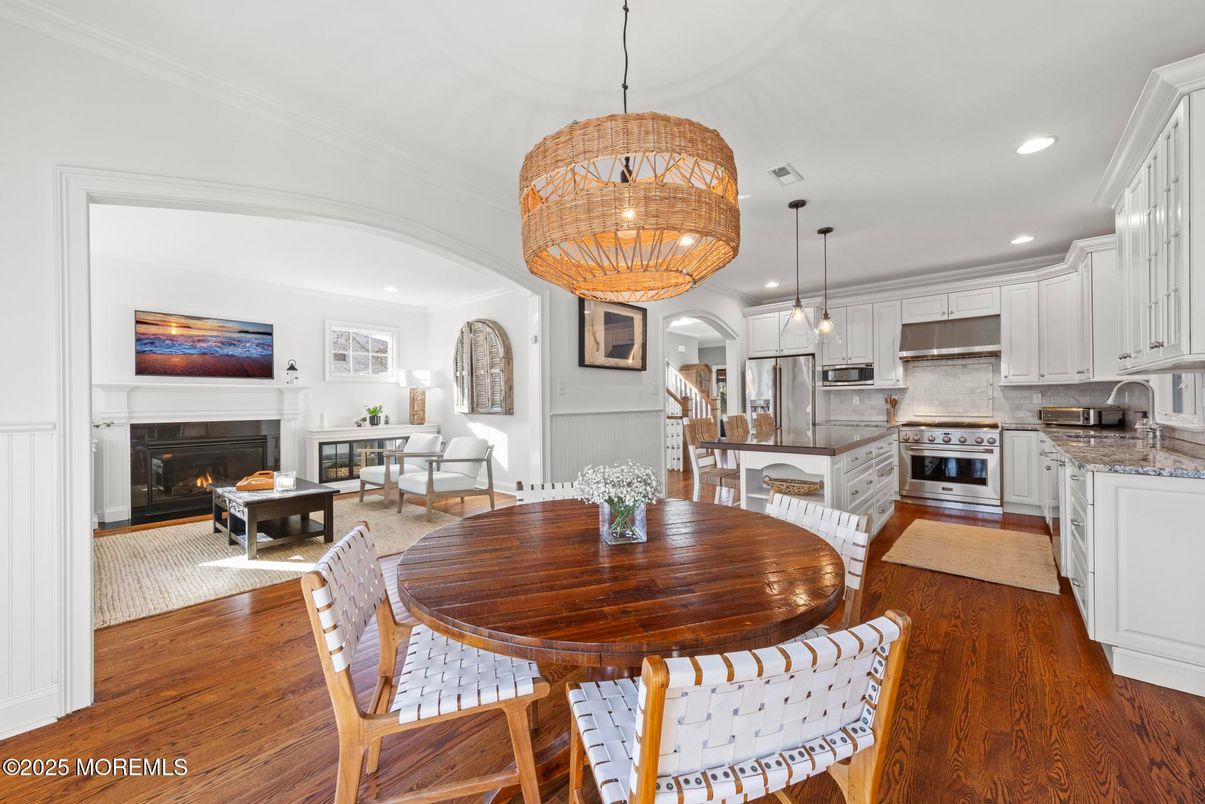 Chandelier, Dining room, Fireplace, Interior, Kitchen, Living room, Pendant Lights, Recessed Lighting, Stainless Steel Appliances, Wood Texture Flooring