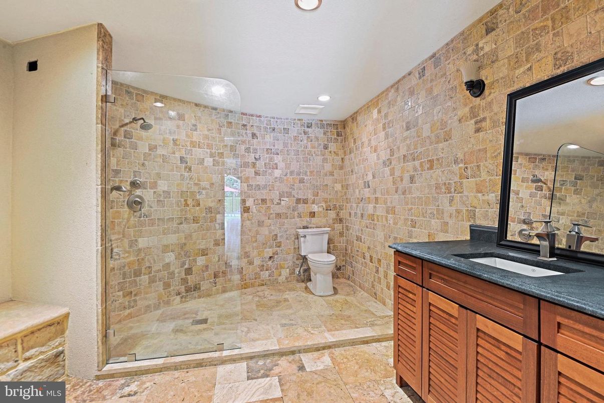 Bathroom, Dual Sink Vanities, Glass Shower, Interior, Recessed Lighting, Stone Walls