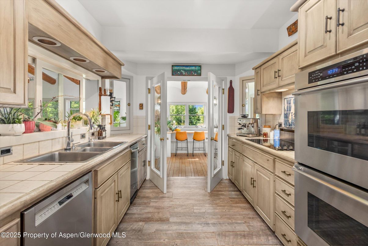 Dining room, Interior, Kitchen, Stainless Steel Appliances, Tile Countertops, Wood Texture Flooring